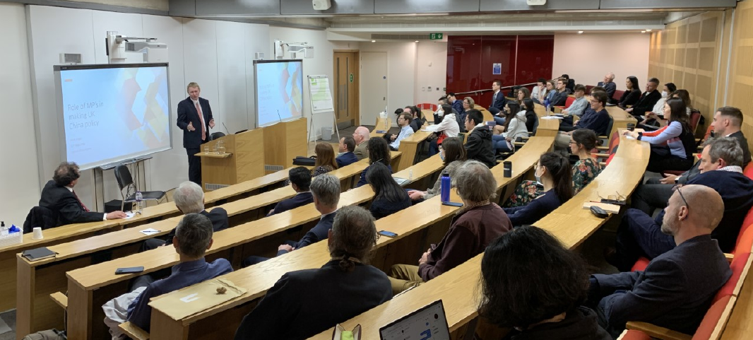 Mark Logan presenting to an audience in a lecture theatre