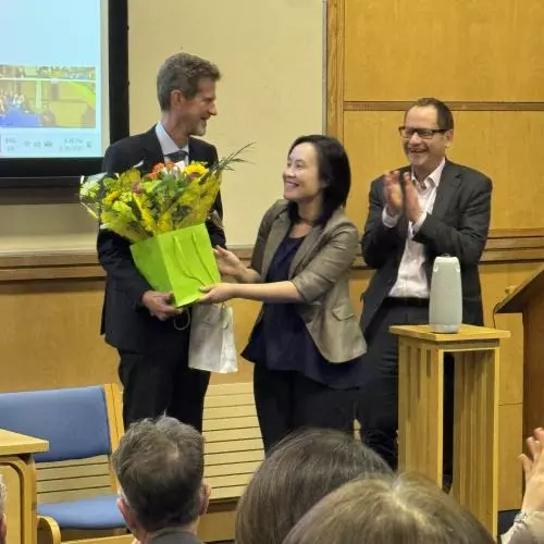 Professor Hugh Whittaker being presented with flowers
