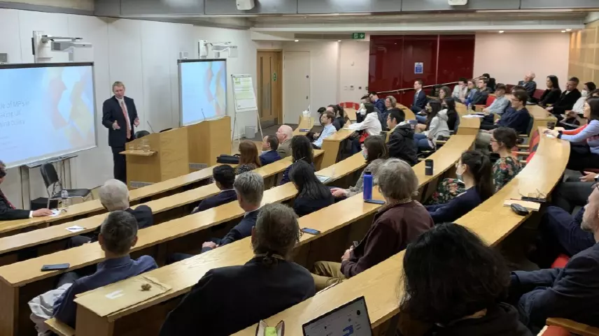 Mark Logan presenting to an audience in a lecture theatre