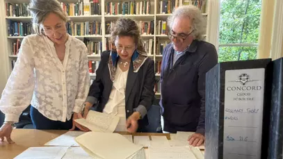 Grace Jaramillo, Rebeca Otazúa and Eduardo Posada-Carbó look at a sample of Rosemary Thorp archives kept in the library at the LAC.