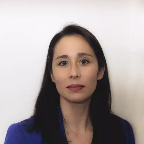 Professor van der Kamp has long dark hair and is wearing a blue blazer