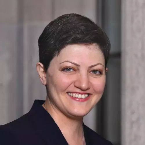 Professor Maryam Alemzadeh has short brown hair. She is wearing a white top and navy blazer