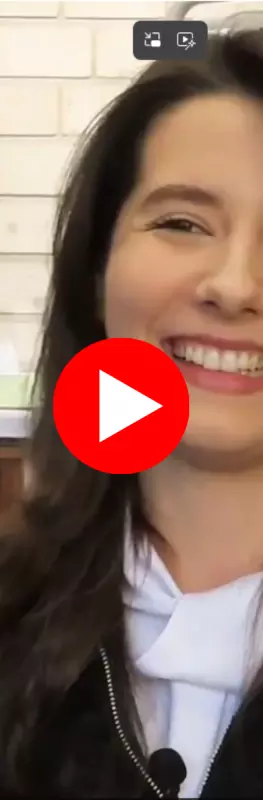 A smiling student with long dark hair 