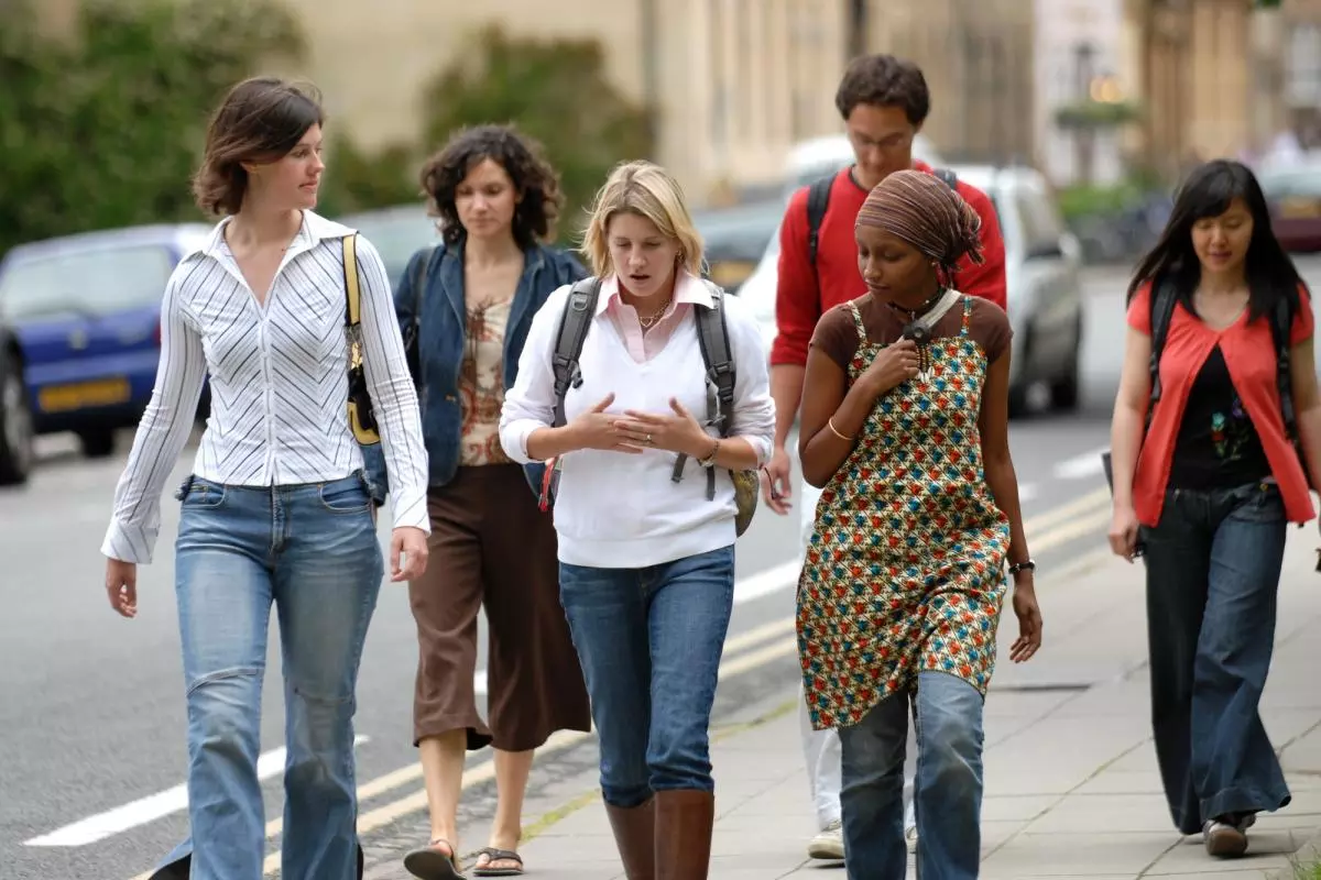 Students in Oxford talking along the street chatting. 